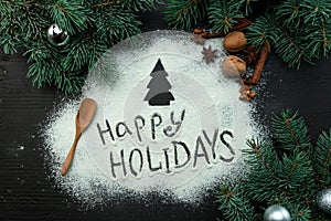 Flour is scattered in the center of the New Year`s composition on a dark wooden background