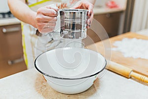 Flour sieved in hands women