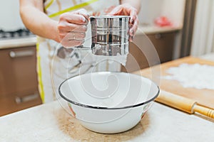 Flour sieved in hands women