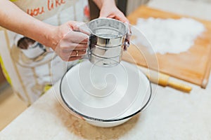 Flour sieved in hands women