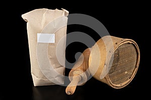 Flour sieved for homemade pastries. Accessories in home kitchen on a dark table