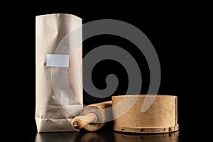 Flour sieved for homemade pastries. Accessories in home kitchen on a dark table