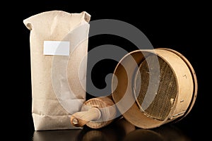 Flour sieved for homemade pastries. Accessories in home kitchen on a dark table