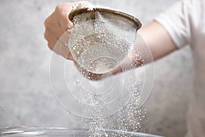 Flour is sieved with a metal sieve