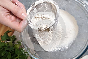 Flour is sieved with a metal sieve