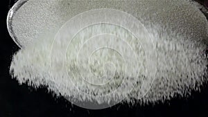 Flour sift flat sieve, black background. Slow motion, bottom view