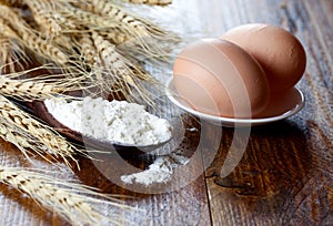 Flour on spoon and eggs