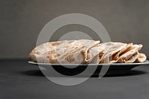 Flour tortillas with bran on a black background