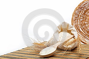 Flour and wheat grain with wooden spoon.