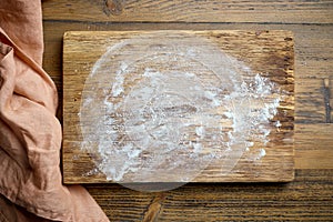 flour on wooden cutting board