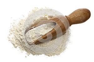 Flour in wooden scoop isolated on white background. Top view. Flat lay