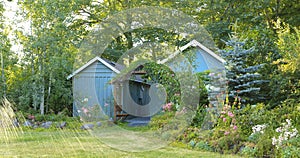 Flourishing farm backyard with sheds and garden house photo