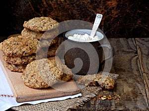 Flourless gluten free peanut butter, oatmeal, dried fruits cookies and cup of cocoa with marshmallows on wooden background. Horizo