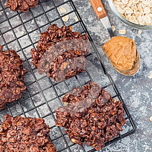 Flourless no bake peanut butter and oatmeal chocolate cookies on cooling rack, top view, square format