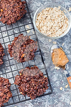 Flourless no bake peanut butter and oatmeal chocolate cookies on cooling rack, vertical, top view