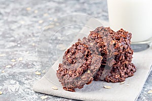 Flourless no bake peanut butter and oatmeal chocolate cookies  with glass of milk, horizontal, copy space