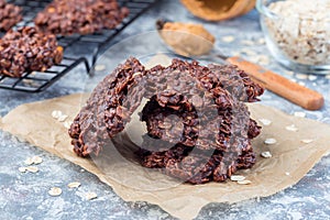 Flourless no bake peanut butter and oatmeal chocolate cookies on  parchment, horizontal