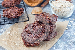 Flourless no bake peanut butter and oatmeal chocolate cookies on  parchment, horizontal