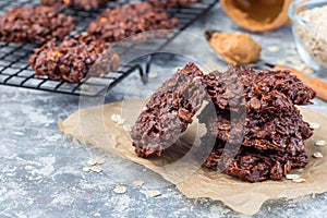 Flourless no bake peanut butter and oatmeal chocolate cookies on  parchment, horizontal, copy space