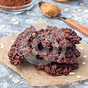 Flourless no bake peanut butter and oatmeal chocolate cookies on  parchment, square format