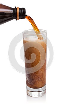 Flow of kvass in glass with froth
