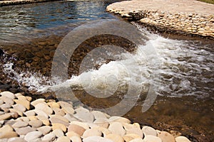 The flow of water in an artificial stream with a bed of pebbles