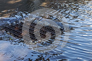 Flow of water during heavy rain and clogging of street sewage. The flow of water during a strong hurricane in storm sewers. Sewage