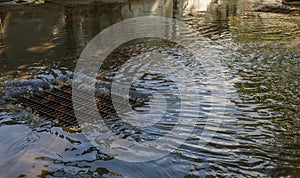 Flow of water during heavy rain and clogging of street sewage. The flow of water during a strong hurricane in storm sewers. Sewage