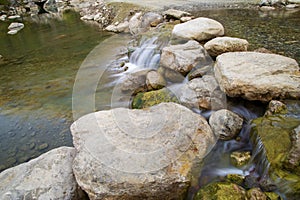 The flow of water of a river at the rock