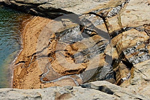 Flow of water from a rock .