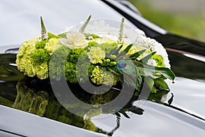 flower arrangement on a black car for a marrage