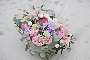 Flower arrangement in a box with spray pink roses, succulent, eustoma, white hypericum, eucaliptus