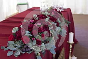 Flower arrangement in Burgundy colors is on the table in the restaurant