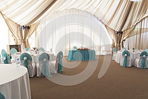 Flower arrangement in delicate colors is on the table for the newlyweds in the restaurant