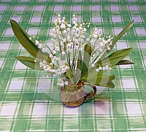 flower arrangement of Lily of the Valley bell-shaped white flowers in Spring photo