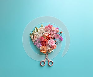 Flower arrangement with scissors on a pastel blue background.