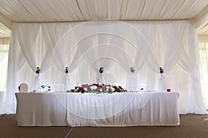 Flower arrangement on the table for the newlyweds in the restaurant