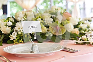 Flower arrangement on the table for the newlyweds in the restaurant