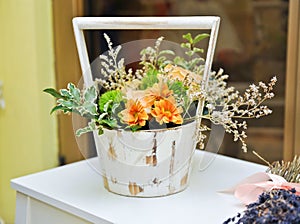 Flower arrangement in white vintage pot. Wedding decoration with yellow flowers