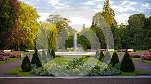 Flower arrangements in symetrical shapes leading up to a fountain in the city park Stadsparken in the town Lund, Sweden