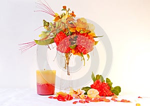 Flower arranging with a burning candle