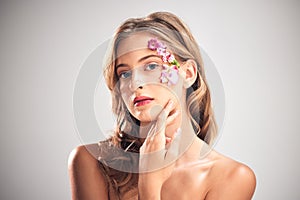 Flower art, beauty and portrait of woman for natural cosmetics, skincare wellness and makeup in studio. Spring, creative