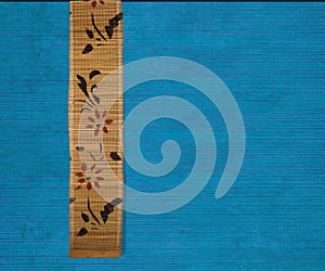 Flower bamboo banner on blue ribbed wood