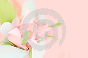 Flower banner. Close up composition of pink Origami paper tulip with green decorations in white box-heart on pink background