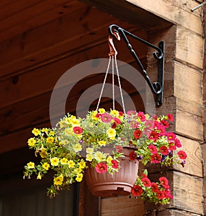 Flower basket hang on country house porch