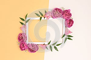 Flower border frame made of rose on a beige and gold background