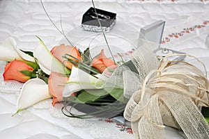 Bouquet of flowers set by orange roses and white coves photo