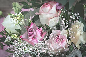 Flower bouquet with pink and white roses on wooden background