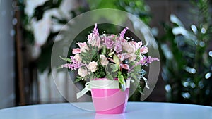 Flower bouquet in the rays of light, rotation, the floral composition consists of gerbera, Eustoma, Rose yana creamy