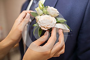 Flower boutonniere in a jacket with hadns